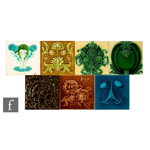 487 - A collection of early 20th Century dust pressed 6 inch tiles, all with relief moulded Art Nouveau fo... 