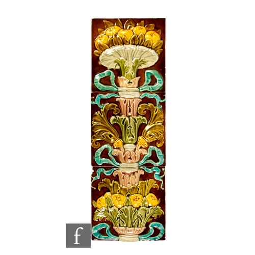 557 - A panel of three 19th Century 6 inch dust pressed majolica tiles, tones of blue, green and pink on m... 