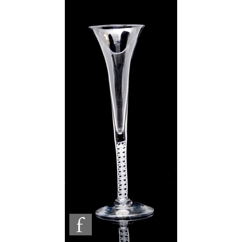 92 - An 18th Century drinking glass or champagne flute, the tall slender drawn trumpet bowl above a doubl... 