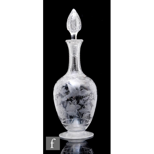 233 - A late 19th Century Stourbridge clear crystal glass decanter of footed ovoid form with slender drawn... 