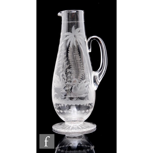 236 - A 19th Century Stourbridge clear crystal water jug, possibly Richardsons, the footed tapered body wi... 