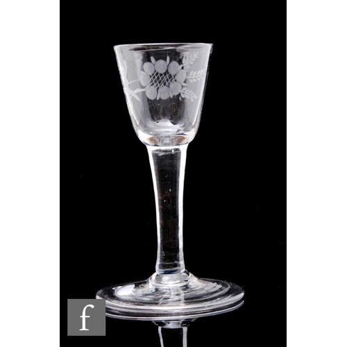 23 - An 18th Century drinking glass circa 1750, the small round funnel bowl engraved with a flower on a s... 