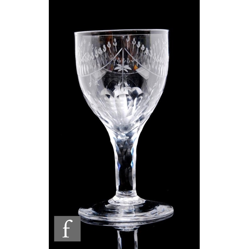 38 - A large 18th Century drinking glass circa 1780, the ovoid bowl engraved with a dairy garland border ... 