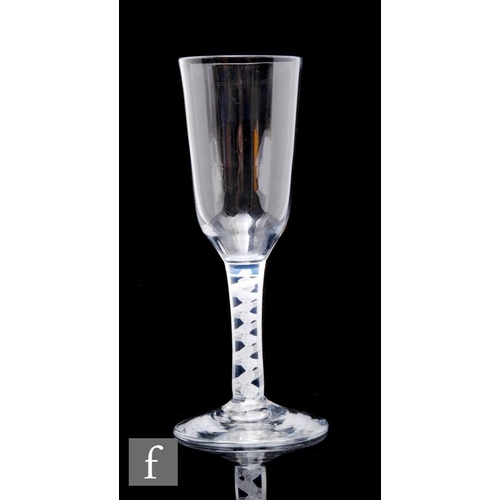 47 - An 18th Century drinking glass circa 1765, the tall ogee form bowl above a double series opaque twis... 