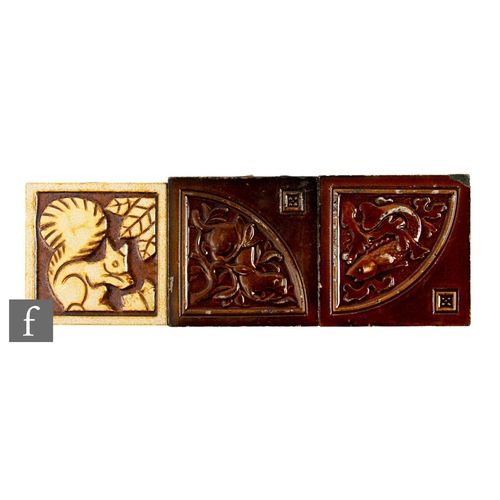 848 - A 1930s Henry Richards 4 inch dust pressed tile, relief carved with a stylised squirrel picked out w... 