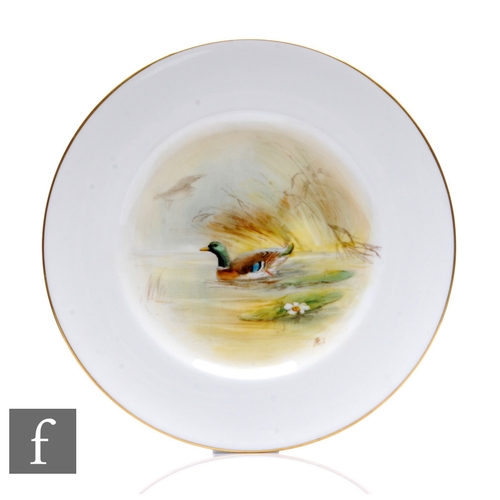 70 - A 20th Century Royal Worcester porcelain plate of circular form, the central well hand enamelled wit... 