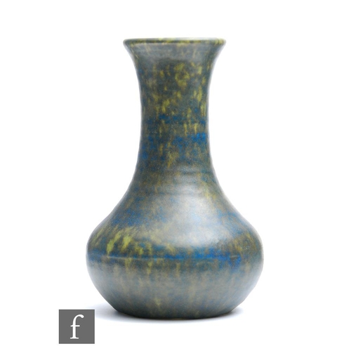 113 - A Ruskin Pottery vase of globe and shaft form decorated in a mottled blue and dark green crystalline... 