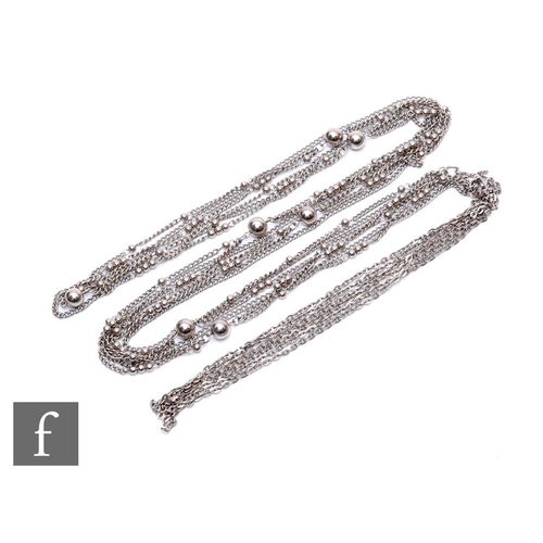 20 - A 1920s white metal long multi-strand 'Flapper' necklace, the four-strands adorned with a series of ... 