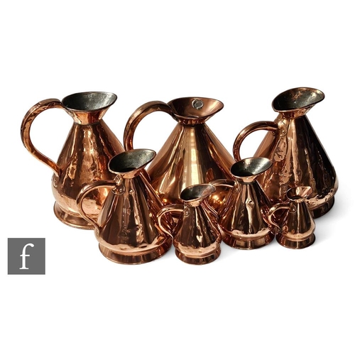 254 - A matched set of set copper ale Jacks including a gallon example, height 32cm. (7)PLEASE VIEW CONDIT... 