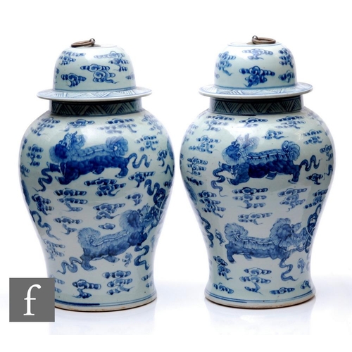 47 - A pair of Chinese blue and white jars and covers, each of baluster form, surmounted by a domed cover... 