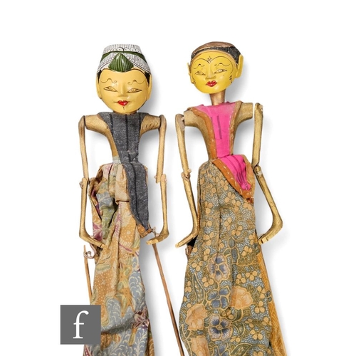 56 - Two early 20th Century Indonesian Wayang Golek rod puppets, with painted and carved wood heads, in t... 