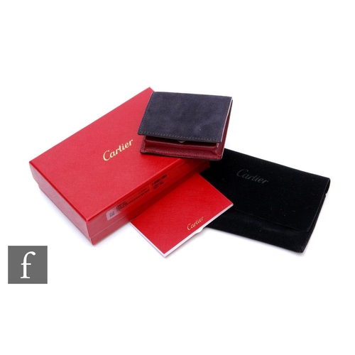 709 - A boxed Cartier suede and calfskin leather coin purse, sold with original box, velvet pouch and pape... 