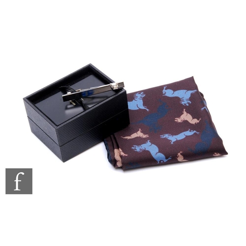 712 - Two Dunhill items, to include a boxed silk bulldog handkerchief/pocket square and a boxed bulldog ti... 