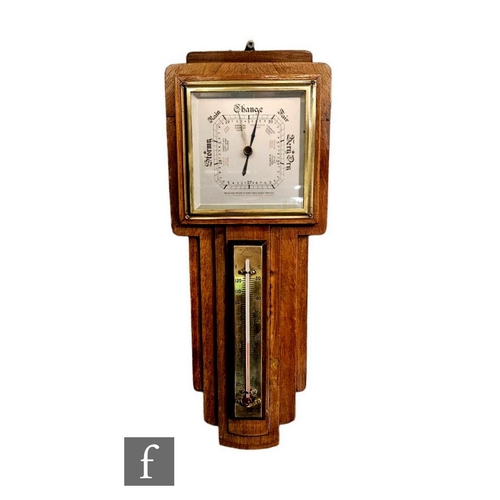 742 - An Art Deco walnut framed aneroid barometer incorporating a brass thermometer stamped Short & Ma... 