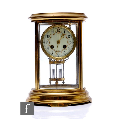 755 - An Edwardian oval brass mantle clock, eight day striking movement, with mercury pendulum, on an oval... 