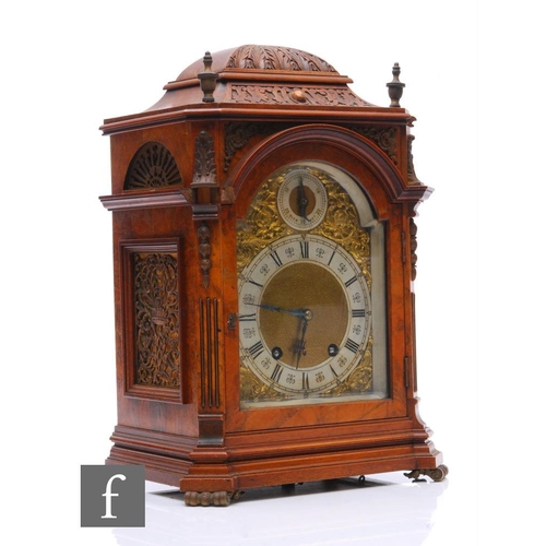 766 - A late 19th Century figured walnut bracket clock, the eight day movement enclosed by an arched dial ... 