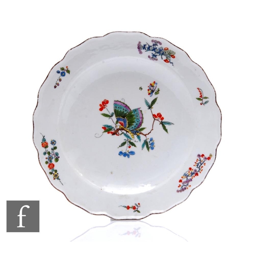 144 - An early 19th Century Meissen plate of circular form with petal-shaped rim, painted with a butterfly... 