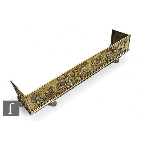 774 - A large late 19th to early 20th Century embossed brass fender, with pressed embossed classical desig... 