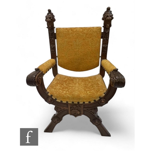 783 - A Victorian carved walnut Savonarola Spanish chair, the backs carved as lion mask heads on a crossed... 