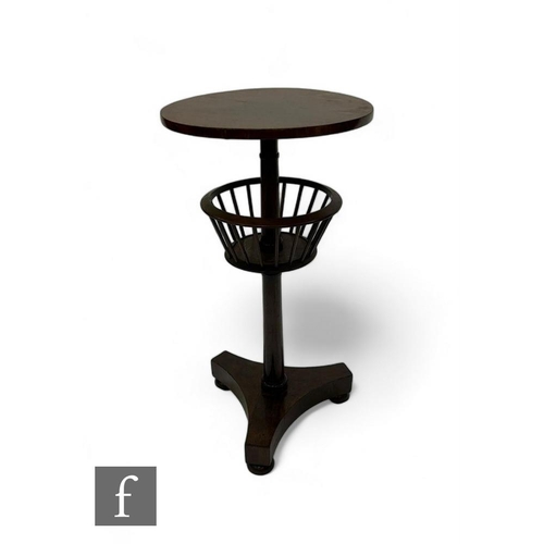 794 - A 19th Century rosewood occasional table, the circular top over a revolving basket on turned pedesta... 