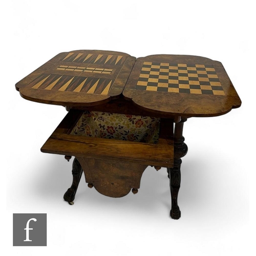 805 - A Victorian figured walnut work/games table, the marquetry swivel inlaid top opening to reveal a che... 