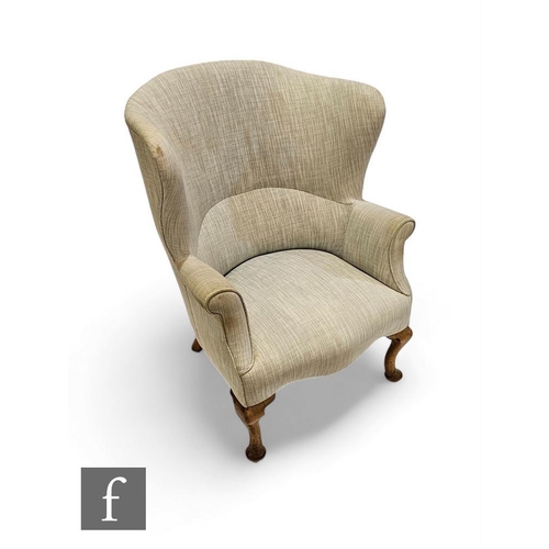 809 - A George III style horseshoe shaped high back easy chair on cabriole legs and pad feet to the front,... 