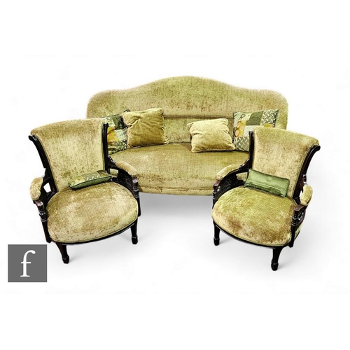 827 - A Victorian three seater settee on turned legs below a shaped undulating back upholstered in green p... 