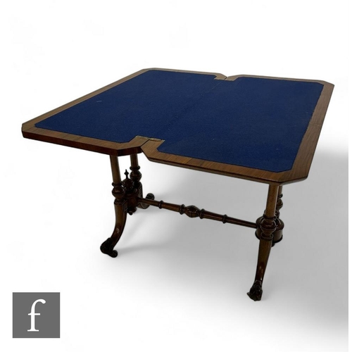 840 - A Victorian crossbanded and line inlaid burr walnut fold over card table, blue baize top on twin pil... 