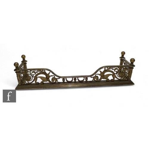 849 - A Renaissance style brass fender, pierced open scroll work design on a stepped plinth base, 135cm.PL... 