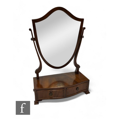 853 - A George III style mahogany dressing table mirror, the shield back over a two drawer base, width 44c... 