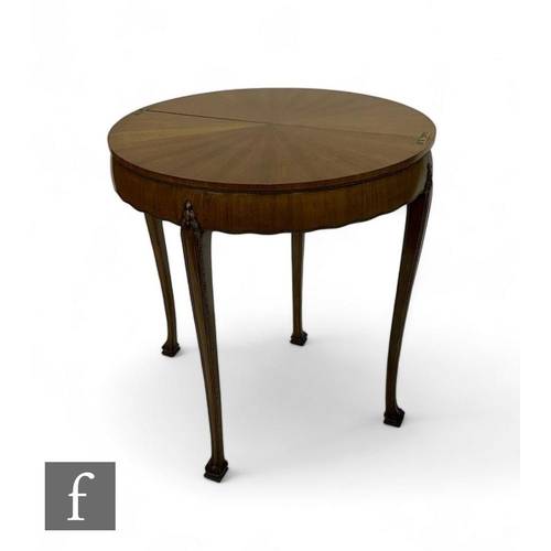 799 - A 20th Century French demi lune fold over table, the radiating walnut top with parcel gilt detail on... 