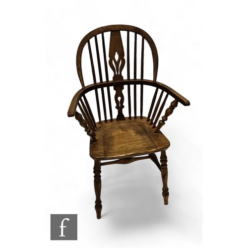 856 - A late 19th Century ash and elm Windsor elbow chair, pieced splat on shaped seat and turned legs.PLE... 