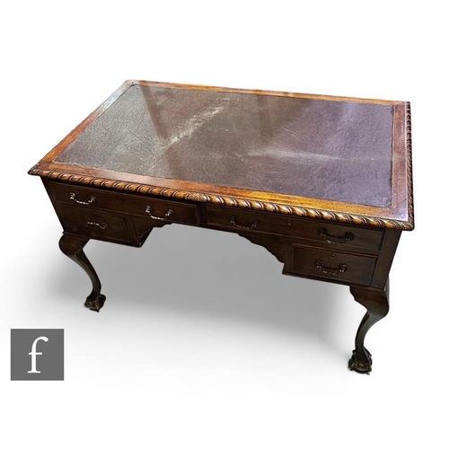 779 - An early 20th Century Chippendale style mahogany kneehole desk, leather inset top over a gadrooned e... 