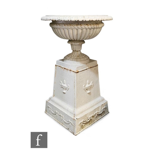 820 - An early 20th Century cast iron circular half fluted terrace vase, on separate plinth base, height 8... 