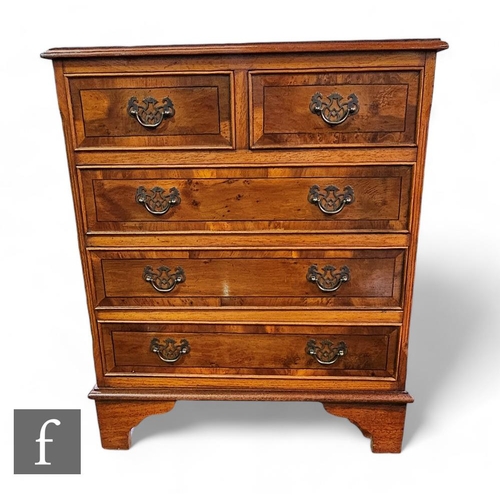 843 - A small George III style yew wood crossbanded chest of two short and three long drawers, on bracket ... 