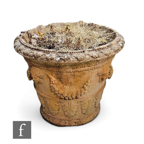 903 - A large terracotta style garden urn, of classical form, decorated with masks and swags of fruits and... 