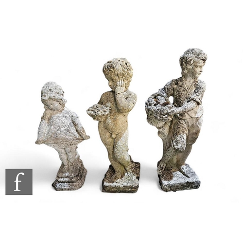 905 - A collection of three reconstituted stone garden figures, modelled as a putti and young girls holdin... 