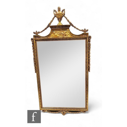 875 - A 20th Century Regency style rectangular gilt wall mirror surmounted with an urn above a bevelled pl... 