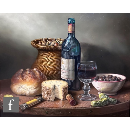 448 - BRIAN DAVIES (1942-2014) - A still life composition with wine bottle, basket of hazelnuts, cheese an... 