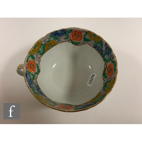 55 - A Chinese Daoguang period teacup, of U form with scalloped rim and loop handle, decorated with figur... 