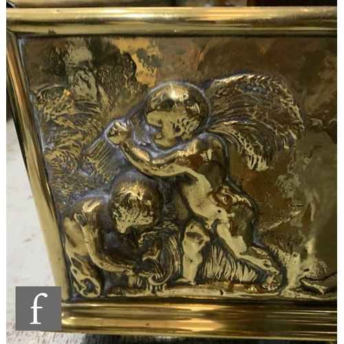 774 - A large late 19th to early 20th Century embossed brass fender, with pressed embossed classical desig... 