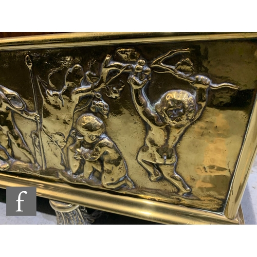 774 - A large late 19th to early 20th Century embossed brass fender, with pressed embossed classical desig... 