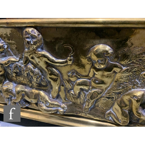 774 - A large late 19th to early 20th Century embossed brass fender, with pressed embossed classical desig... 