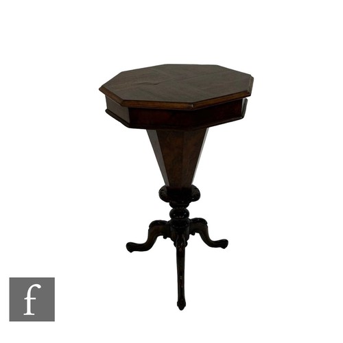 838 - A Victorian mahogany trumpet shaped octagonal work table, fitted interior on turned pedestal and car... 