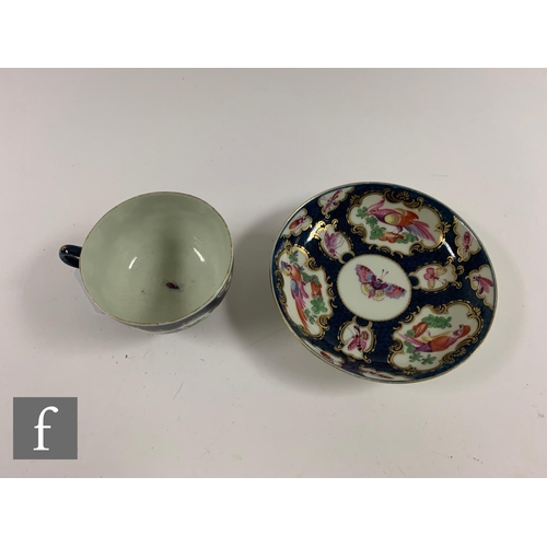 209 - A late 18th Century Worcester blue scale ground teacup and saucer, with hand painted cartouche panel... 