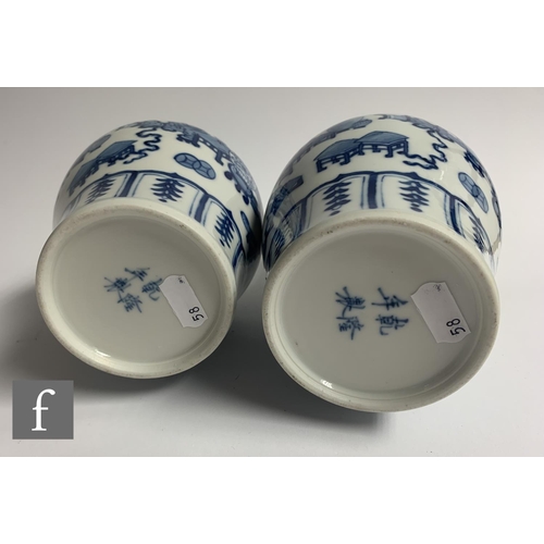 58 - A pair of Chinese Kangxi style blue and white 'Arrow' vases, each of baluster form, decorated with p... 