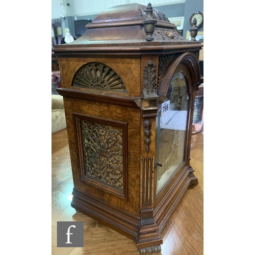 766 - A late 19th Century figured walnut bracket clock, the eight day movement enclosed by an arched dial ... 