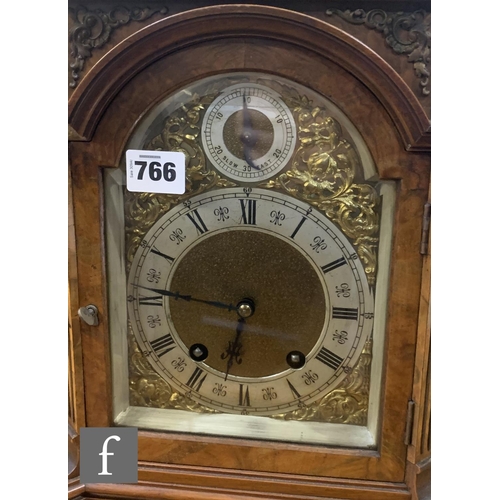 766 - A late 19th Century figured walnut bracket clock, the eight day movement enclosed by an arched dial ... 