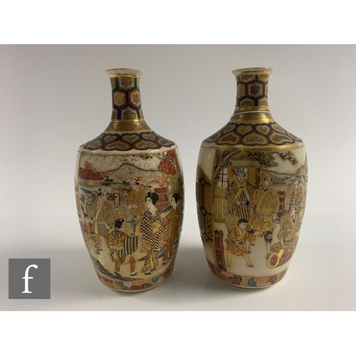 27 - A pair of Japanese satsuma vases, each of bottle form, the body of each with opposing mirror images,... 