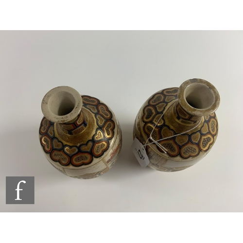 27 - A pair of Japanese satsuma vases, each of bottle form, the body of each with opposing mirror images,... 